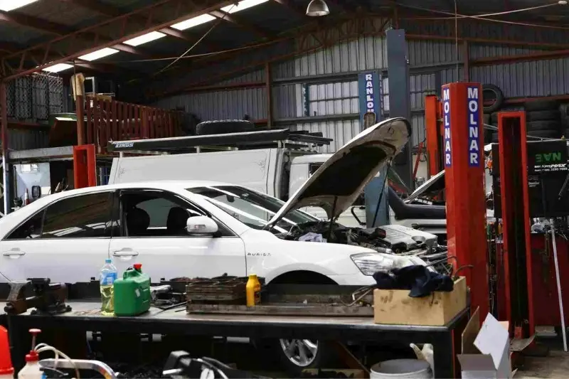 Car being serviced in an auto repair shop.