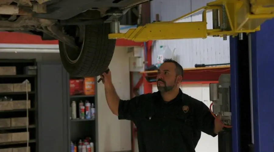 Professional pre-purchase vehicle inspection mechanic examining used car comprehensive assessment Logan