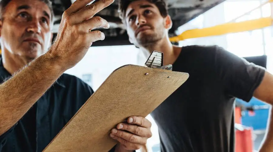 Professional pre-purchase vehicle inspection comprehensive checklist mechanic examining used car systems Logan