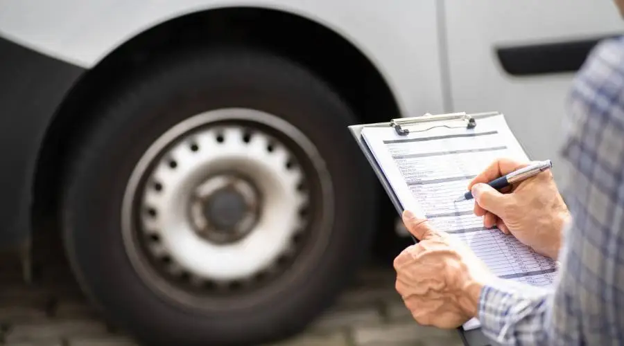 Car owner preparing vehicle for Queensland roadworthy inspection using comprehensive checklist