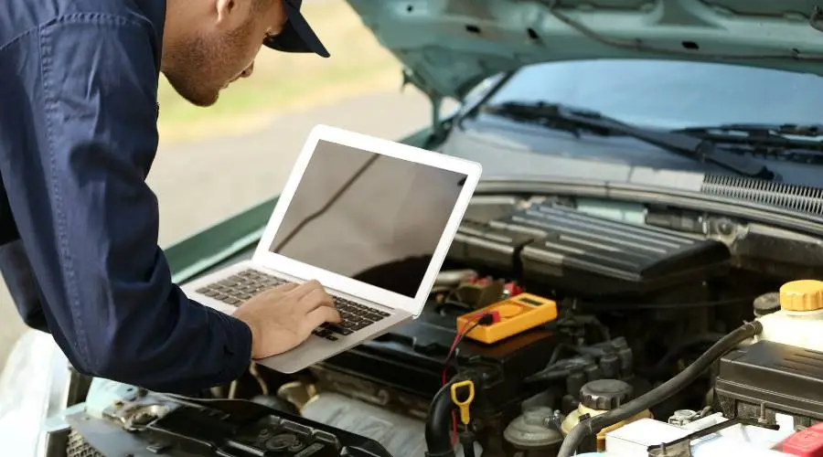 Engine bay pre-purchase inspection mechanic checking oil leaks belts hoses diagnostic assessment