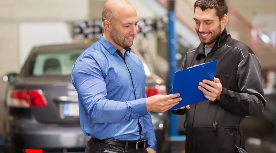 Licensed Queensland examiner presenting completed roadworthy safety certificate to vehicle owner