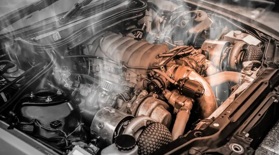 Car temperature gauge overheating warning with steam from engine bay cooling system problem