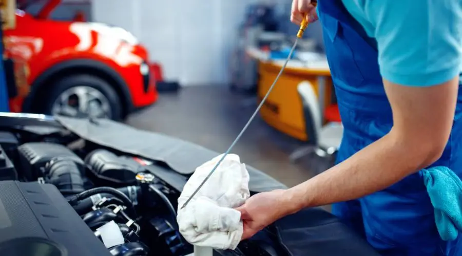 Professional mechanic checking automotive fluid levels power steering brake coolant with service reminders