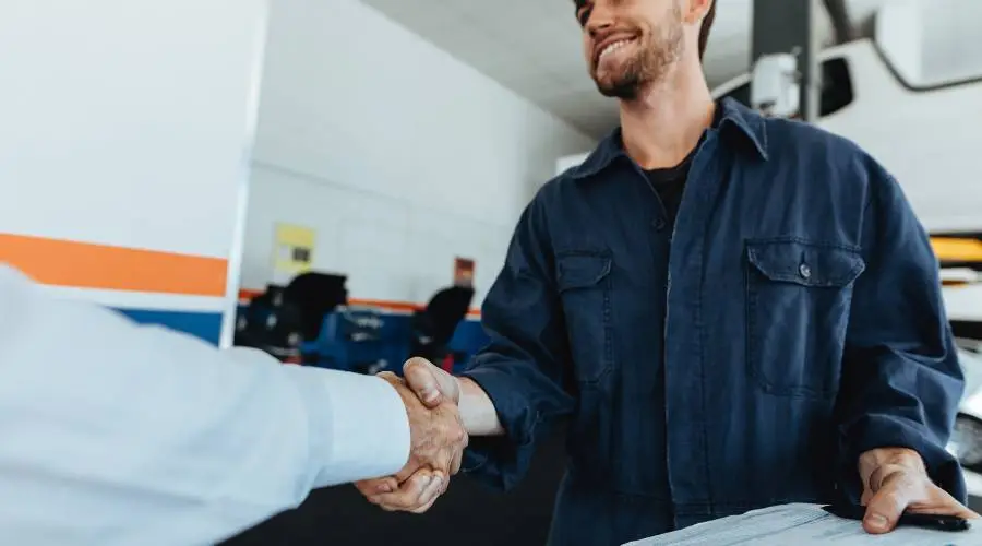 Happy car owner displaying passed Queensland roadworthy certificate after thorough preparation