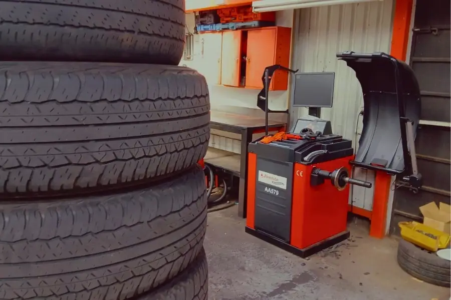 Tire balancing machine in auto repair shop.