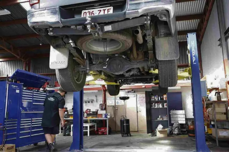 Car on lift in auto repair shop