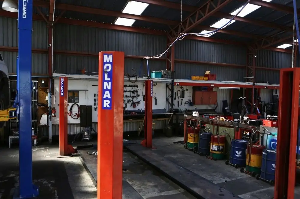 Automotive workshop with car lifts and tools.