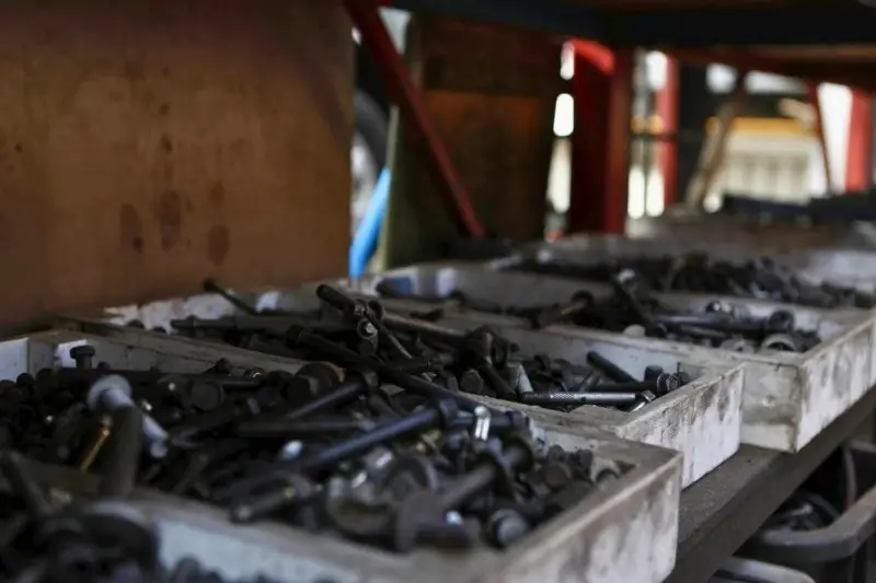 Assorted bolts in trays on workshop shelf