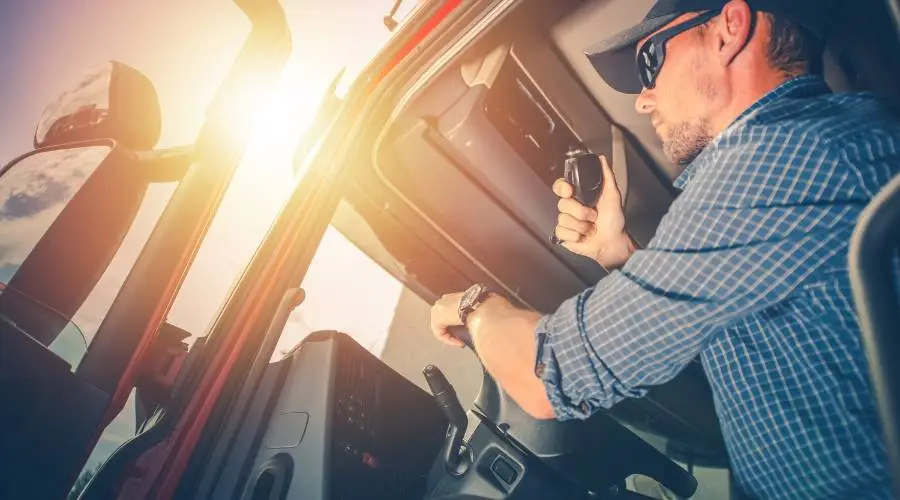 Truck driver using radio in cabin